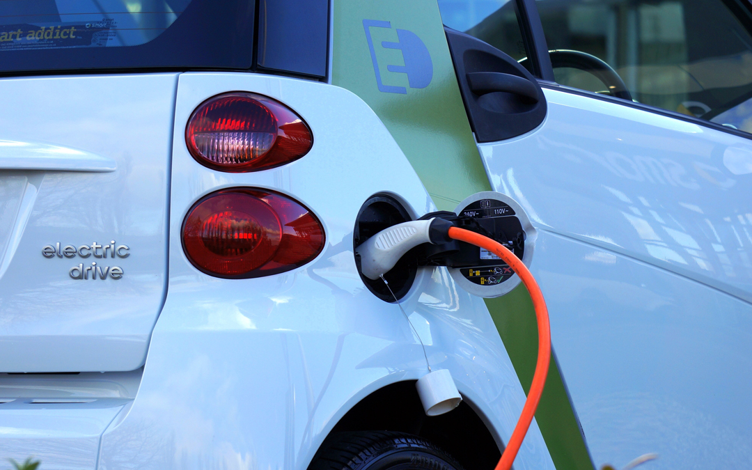Image of electric car plugged into charger